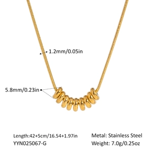 Detail of gold stainless steel snake chain necklace with eight interlocking gold rings