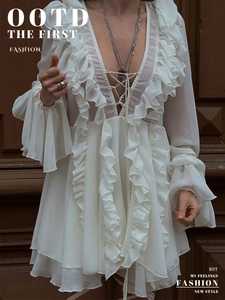 Detailed view of the deep V-neckline with cross-lace ties and ruffle chiffon texture