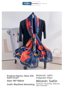 Detailed look at silk satin long scarf with orange floral print and machine-rolled hem