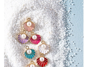 Macro detail of colorful shell enamel charms with central pearls for DIY jewelry making