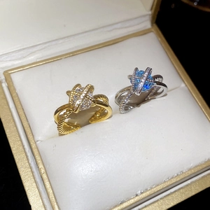 Detailed macro view of X-shaped cross rings with twisted band and cubic zirconia