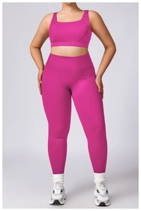 Front view of a rose red high-waisted yoga set with sports bra and leggings on a model