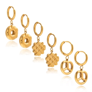 Detailed view of gold stainless steel earrings in doughnut, waffle, and pretzel shapes