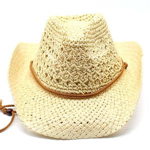Detail of hollow woven beige straw cowboy hat with adjustable beaded wind strap