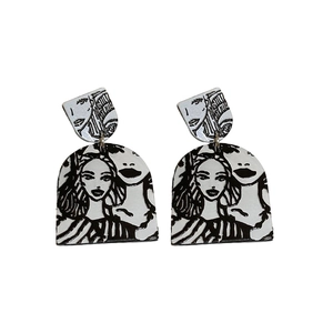 Unique abstract face line art drop earrings in silver metal with black and white design