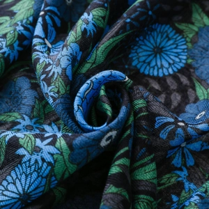 Macro shot of dark blue and green floral prints on soft cotton-linen fabric texture