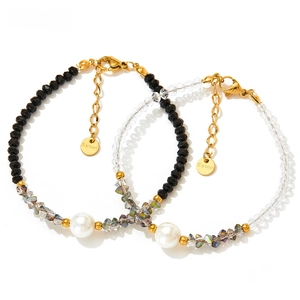 Detail of faceted crystal beads and pearl charms on stainless steel chain bracelets