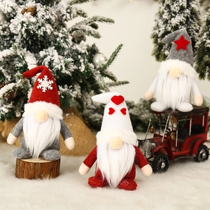 Three Christmas gnomes set with red, white and grey hats for festive home decoration
