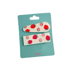 Set of two strawberry pattern resin hair clips with glitter on a teal card display