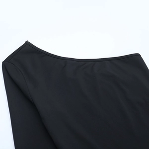 Detail of the elegant neckline and fine knitted texture on the black long sleeve top
