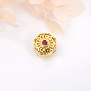 18k gold-plated hexagonal hollow spacer bead with a red gemstone for DIY jewelry making