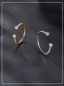 Detailed view of gold and silver S925 open rings with dual four-prong moissanite stones