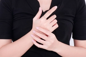 Detail of minimalist rose gold stackable rings shown on model for a sleek daily style