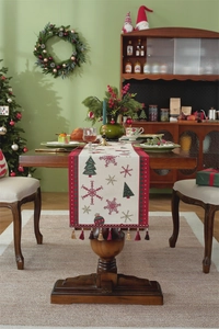 Detailed embroidery of Christmas tree and snowflake patterns on a woven table runner