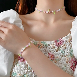 Floral beaded necklace and bracelet set with pink and white flower charms for women