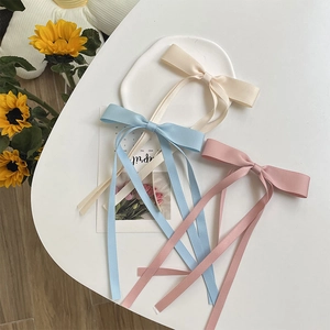 Three-piece satin ribbon bow hair clips in cream white, light blue and soft pink colors