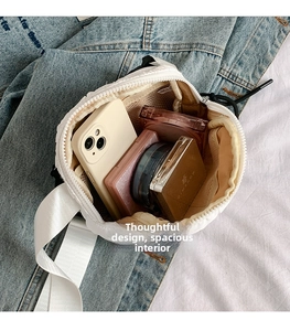 Detailed interior of white quilted crossbody bag showing spacious storage with mesh pocket