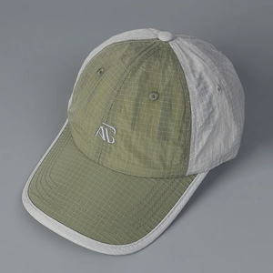 Detail of grid quick-dry fabric and white AG embroidery on a casual baseball cap