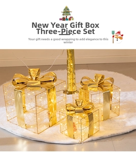 Three-piece gold lighted Christmas gift boxes with warm LED lights and large shiny bows