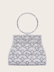 Detailed silver clutch with crystal fan pattern and round metal handle on beige background