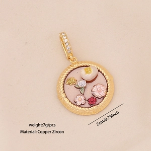 Close-up of gold flower charm pendant showing 2cm diameter and cubic zirconia details