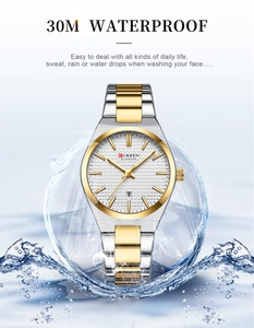 Macro shot of silver and gold men quartz watch showing 30M water resistance splashes