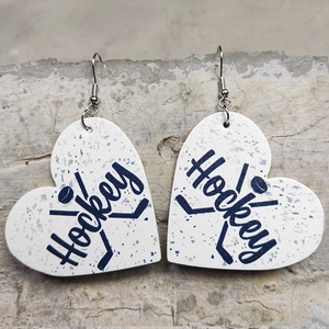 Detail of heart-shaped faux leather hockey earrings with blue patterns on stone