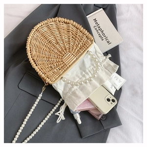 Internal view of handmade bamboo woven bag with white drawstring lining and pearl straps
