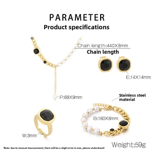 Detail of chunky stainless steel jewelry set with black gemstones and white pearls