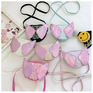 Flat lay detail showing a variety of colors for kids sequin crossbody bags with angel wings