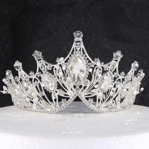 Vintage silver baroque bridal crown with crystals and pearls on a round white base
