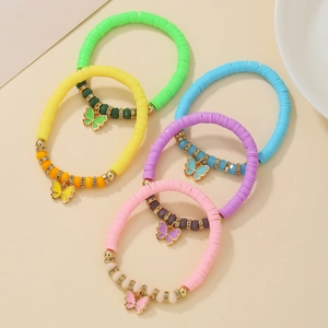 Detail of five colorful fruit clay stretch bracelets with crystal beads and butterfly charms