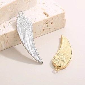 Street style titanium steel wing pendants in gold and silver finish on stone base