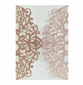 Close-up of laser-cut European floral pattern on rose gold glitter invitation cover