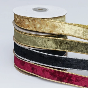 Close-up of velvet Christmas ribbons with gold edges in burgundy green and black colors