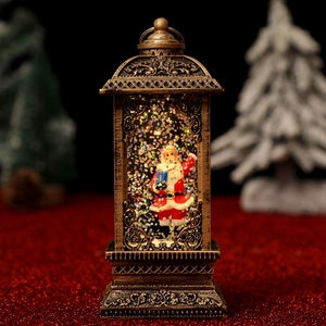 Detail of vintage bronze Christmas lantern with Santa Claus and swirling snow glitter inside