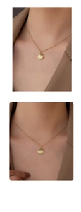 Detail of S925 silver golden seashell pendant necklace on fine bead chain and blazer