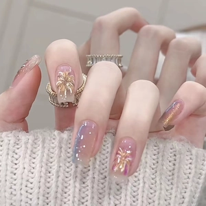 Elegant gold fireworks press-on nails with golden rings on a soft beige background