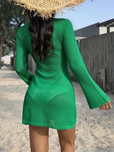 Back view of a green knit mesh long sleeve mini dress perfect for beach vacation wear