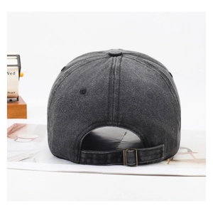 Detail of vintage washed baseball cap back with adjustable brass buckle and worn texture