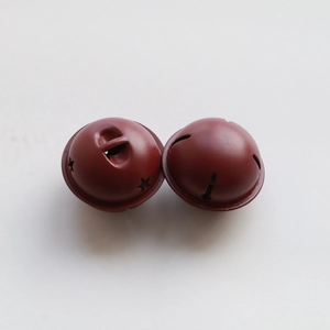 Macro view of two 4cm red metal star-cutout bells for DIY Christmas decor