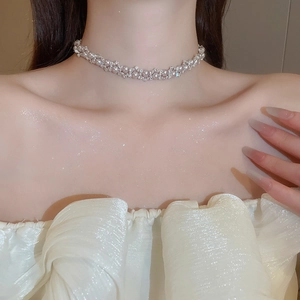 Close-up of elegant rose pearl necklace with zircon details on a model neck