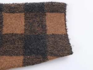 Macro view of checkered knit fabric in deep brown and charcoal black wool blend