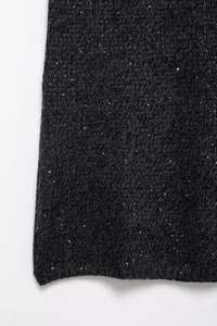 Detail view of dark grey tweed fabric with silver sequins and intricate knit texture