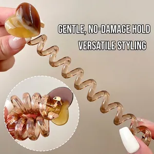 Amber heart spiral hair tie showing high elasticity and translucent resin texture