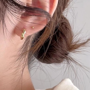 Minimalist 925 sterling silver gold-plated twisted hoop earrings and bead studs on model