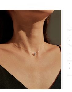 Close-up of minimalist Moissanite pendant with invisible fishline chain on a neck