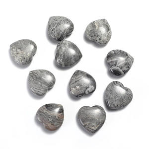 Flat lay of ten heart-shaped grey natural stone ornaments with smooth polished texture