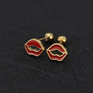 Macro view of gold-plated red enamel lip stud earrings with screw-back closures