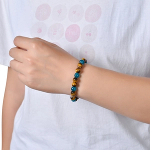 Tiger eye and blue crystal beaded fortune bracelet with gold spacers on a wrist